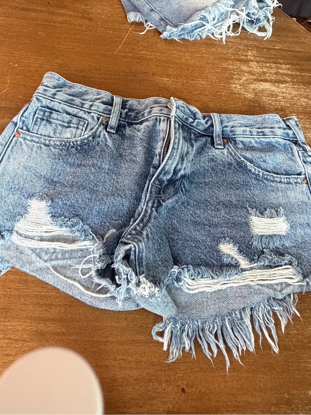 Pacsun blue denim shorts with frayed hem and distressed details